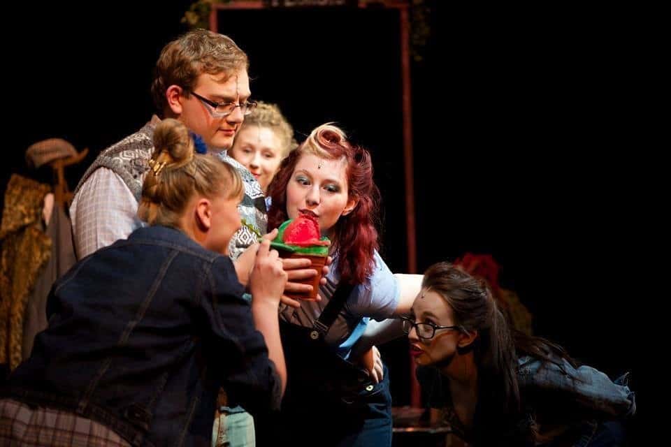 students singing and acting on a theatre stage
