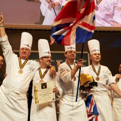 Kristian Curtis (fourth chef from the left) celebrating on stage with his teammates.