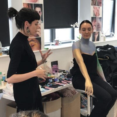 teacher explaining how to apply body paint