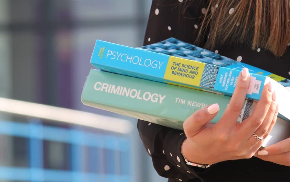 student carrying psychology book