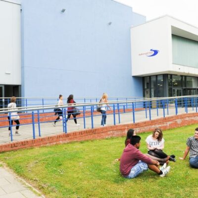 Students sat in front of campus