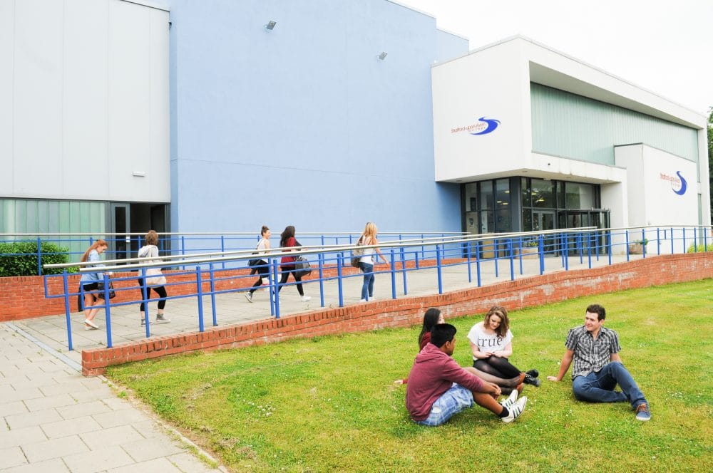 Students sat in front of campus