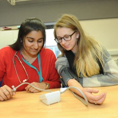 student taking blood pressure of other pupil