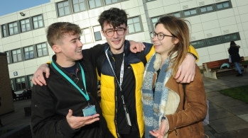 Students embrace outside college building. School Leaver Advice Days.