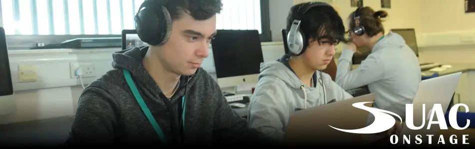 Music students work at laptops.