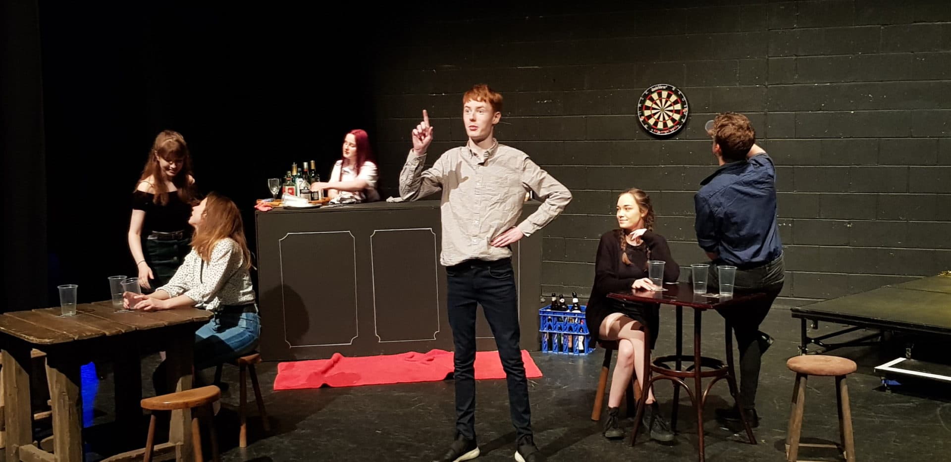 Acting students act on a set.