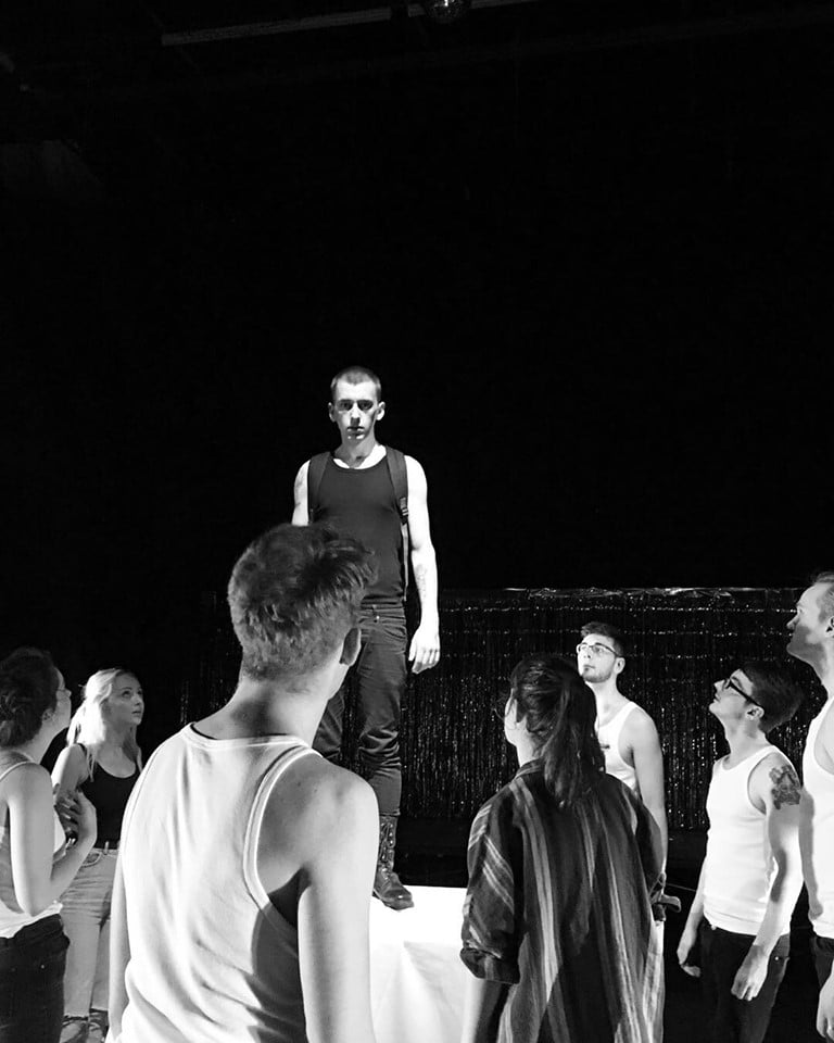 Student perform a musical on stage.
