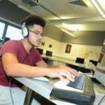 Music student using keyboard.