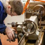 Engineering student using machine.