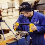 Engineering student uses tools.