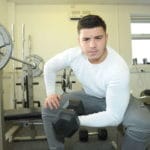 Student exercising with dumbbell