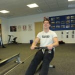 Sports student on rowing machine.
