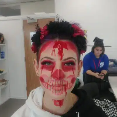 Student has make up on face of red skull