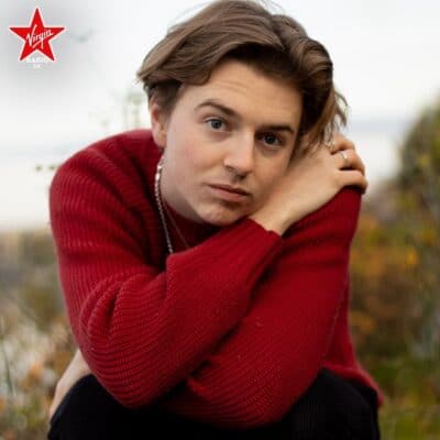 Isaac wearing red jumper looking at camera