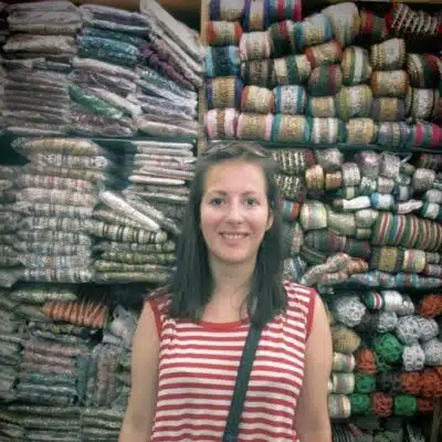 Louisa standing in front of material