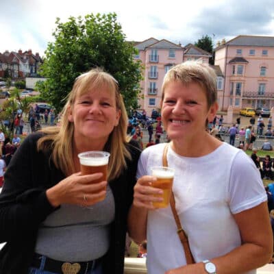 Two women holding drinks