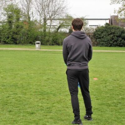 Student talking to other students in park at Stratford-Upon-Avon College