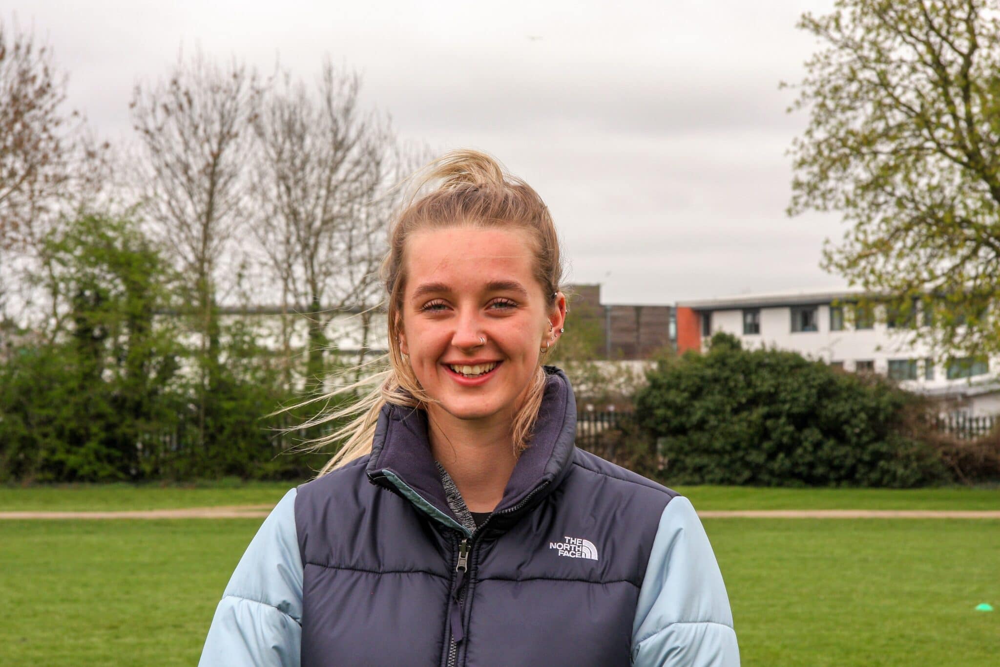 Student looking at camera smiling at Stratford-Upon-Avon College