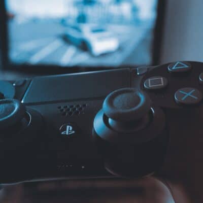Playstation Remote Control with TV in Background