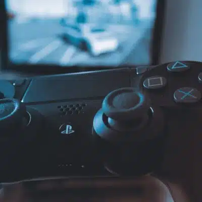 Playstation Remote Control with TV in Background