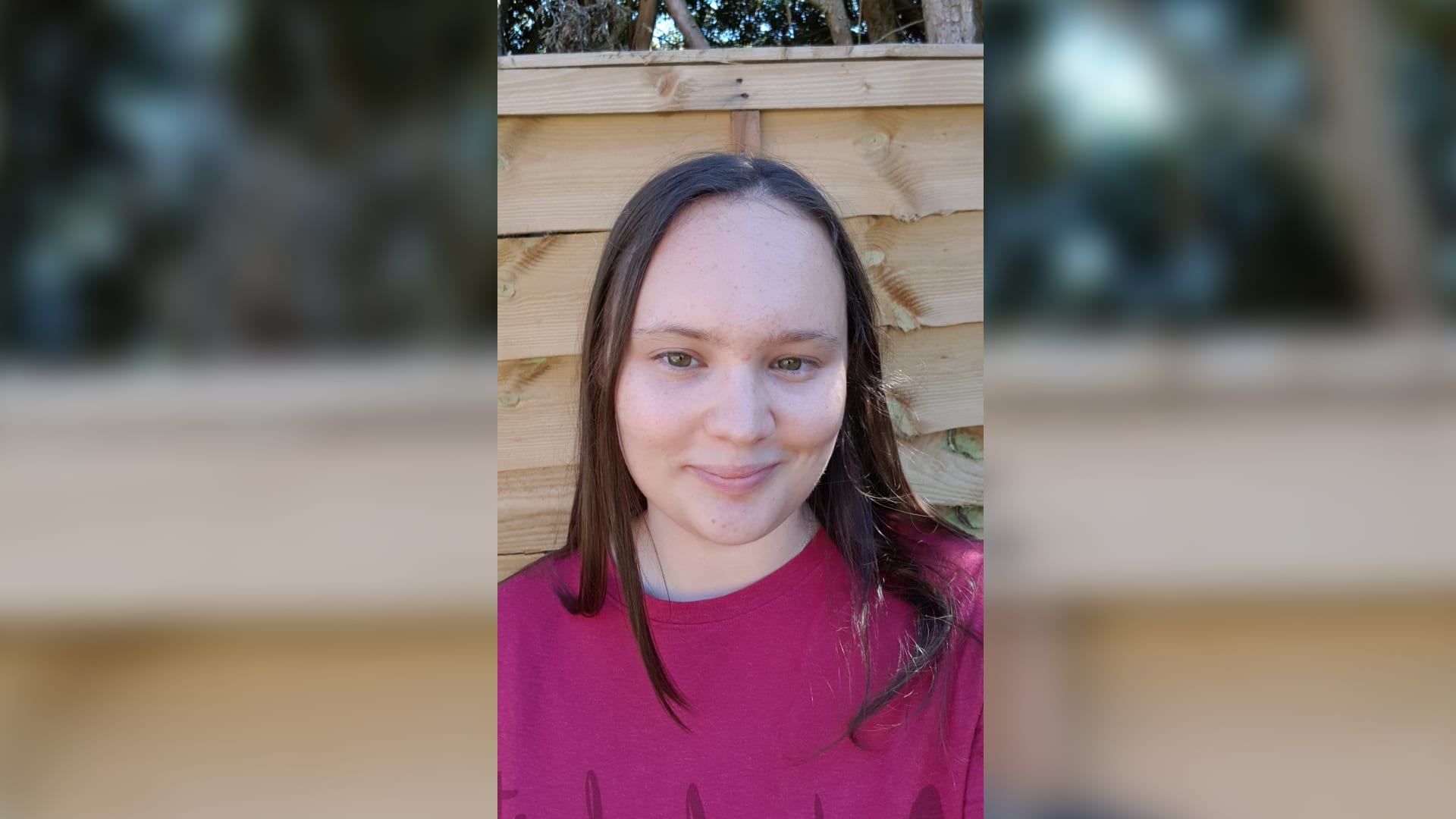 Student wearing pink looking at camera