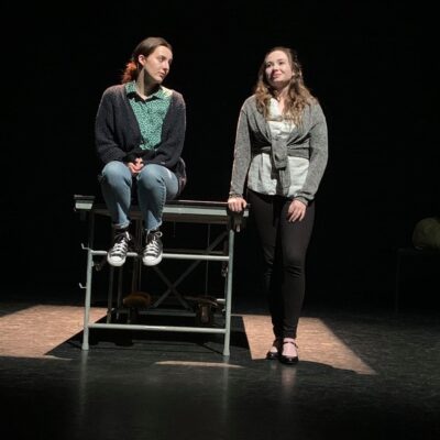 students sat and standing on stage