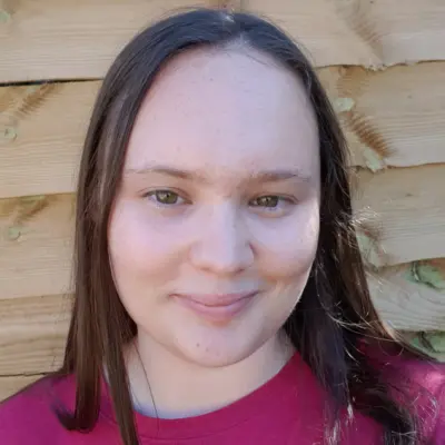 Student wearing pink looking at camera