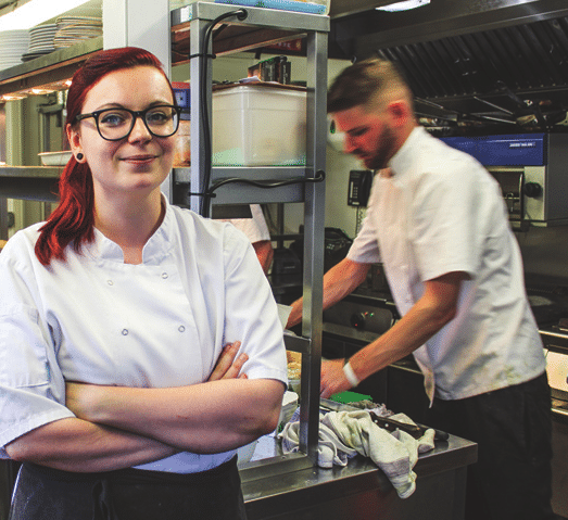 Catering student working in kitchen