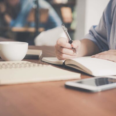 student writing in notebook