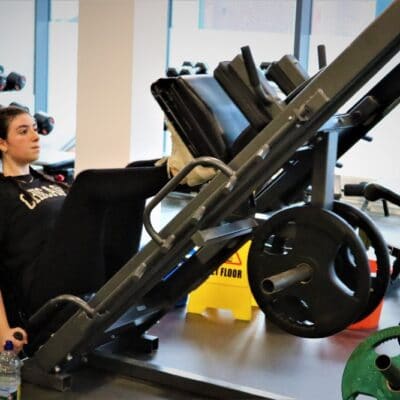 Student on leg push equipment