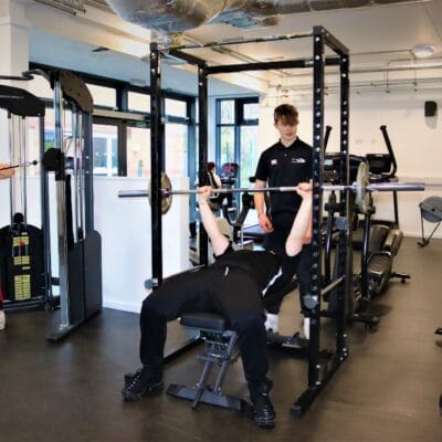 Student on weight lift equipment