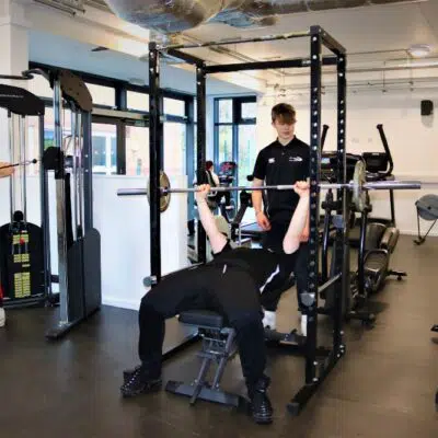 Student on weight lift equipment