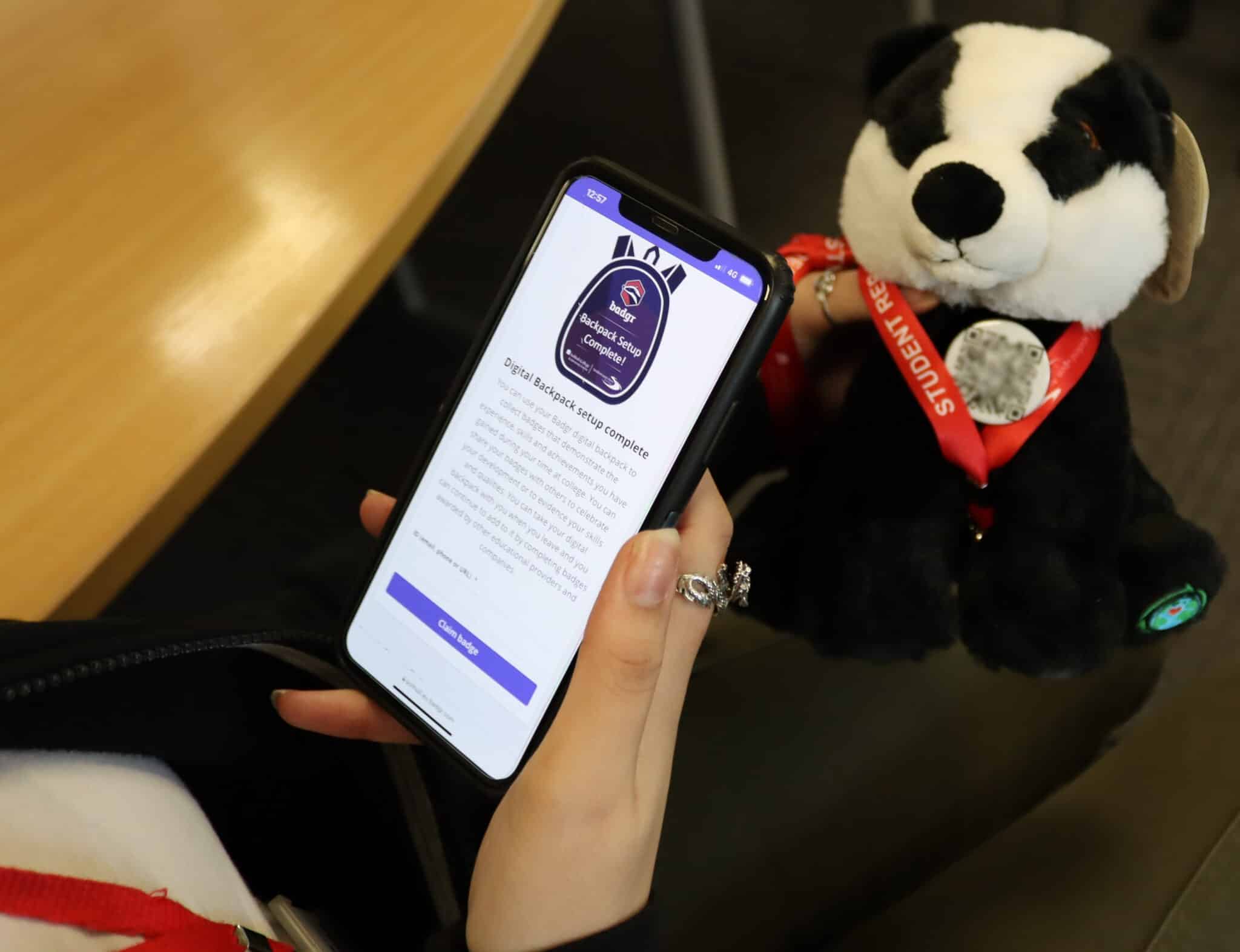 Badger with student phone