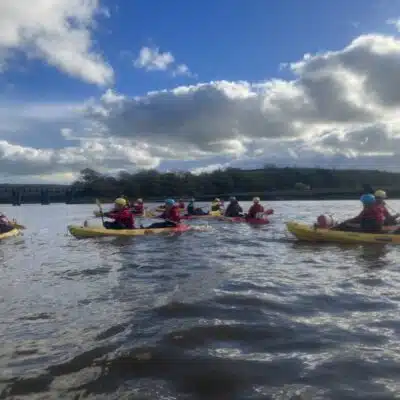 Public Service Students taking on rafting in yellow boats