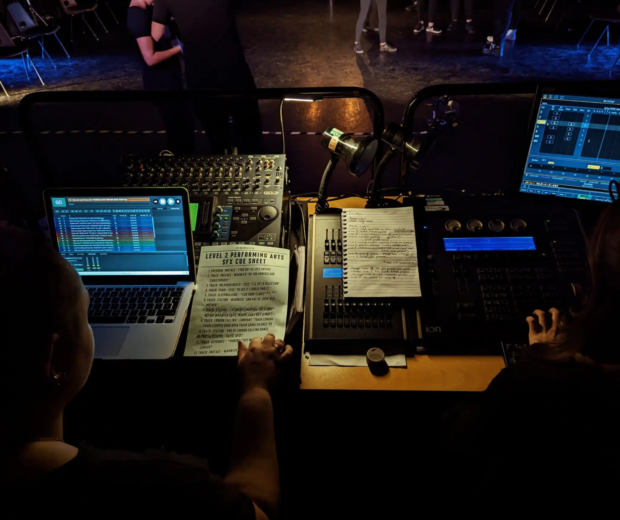 Students in a theatre control booth.