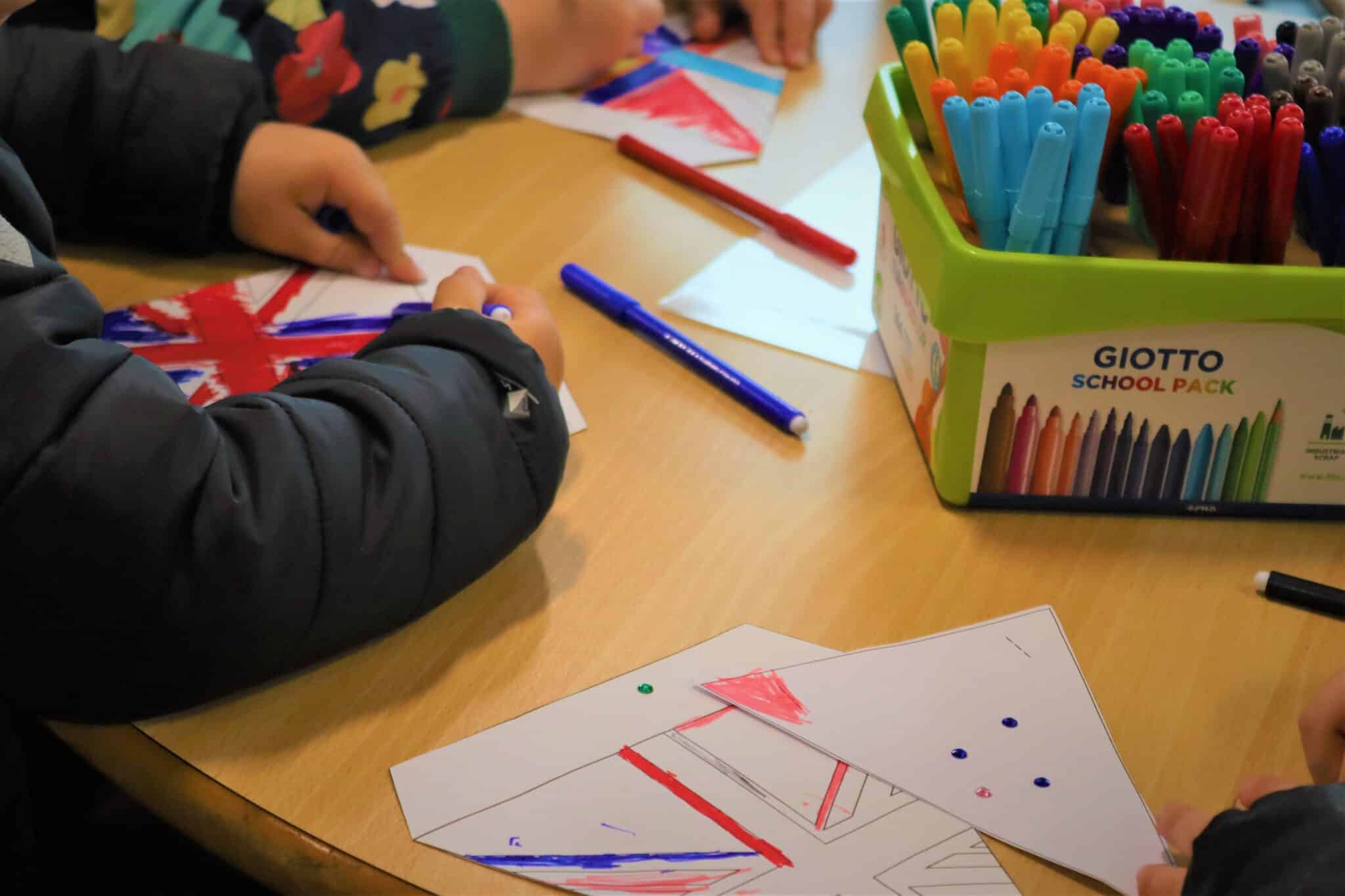 Highlighters being used to colour in the Union Jack as a paper flag