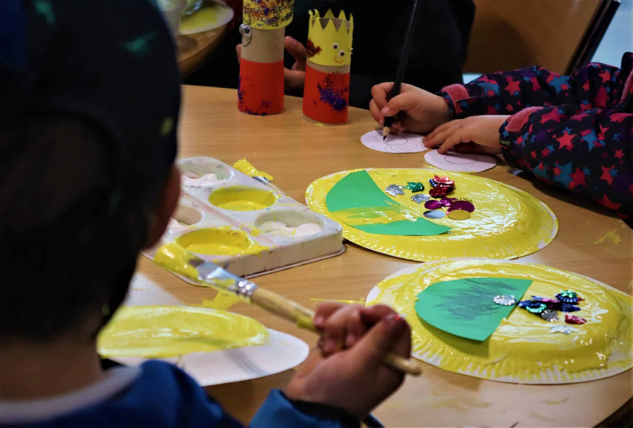 People working on crafts at coronation event with the local community