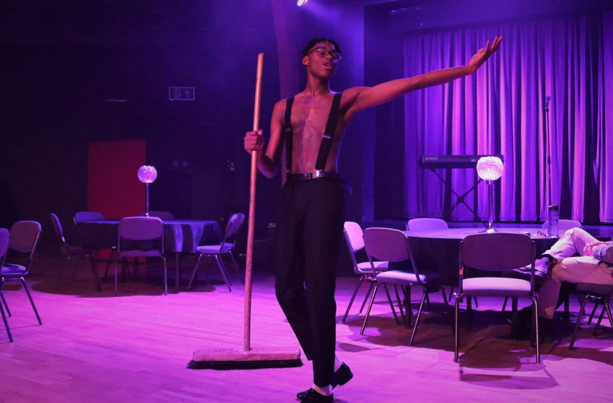 Student dancing with a broom in cabaret