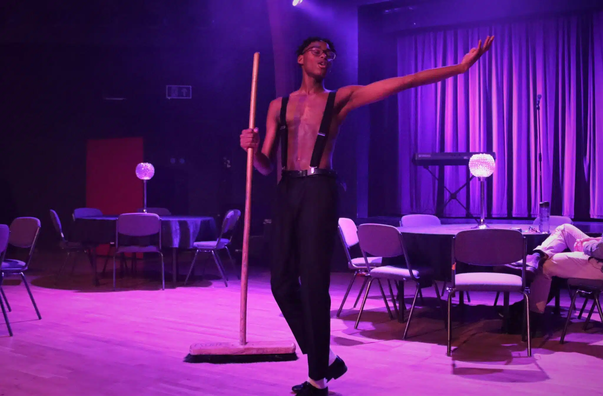 Student dancing with a broom in cabaret