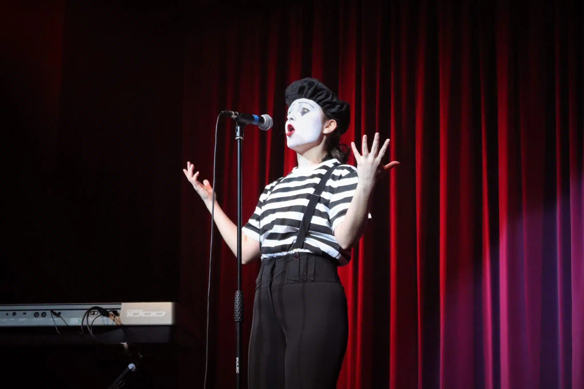Student dressed as mime on mic