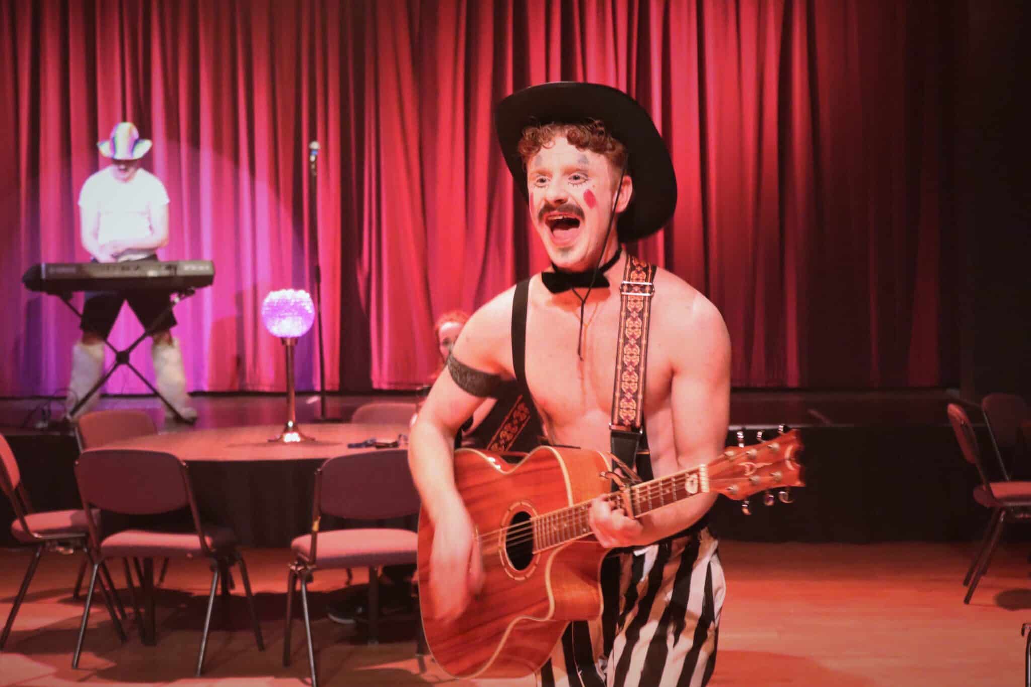 Student in cabaret on guitar