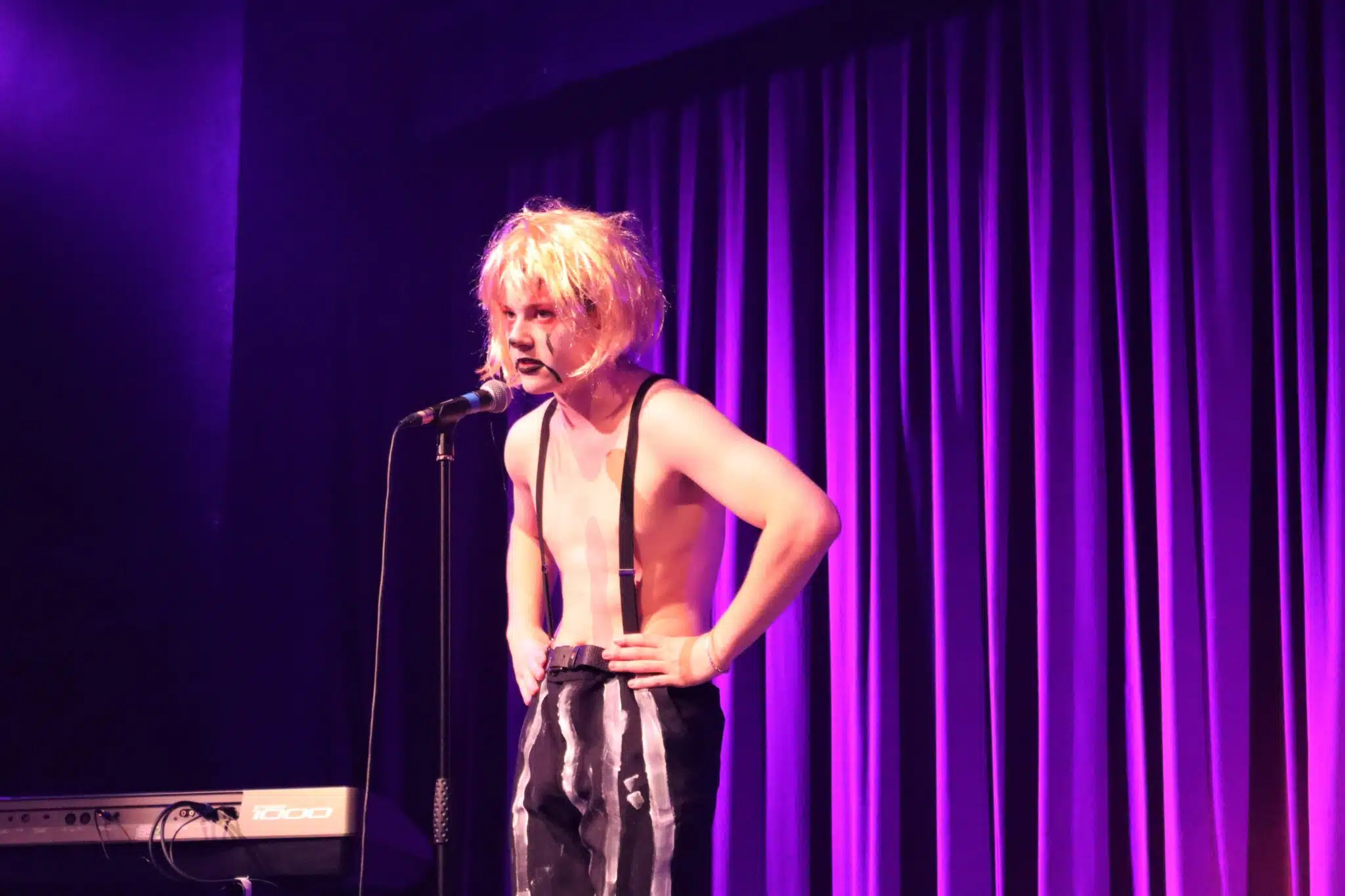 Student in wig on cabaret mic