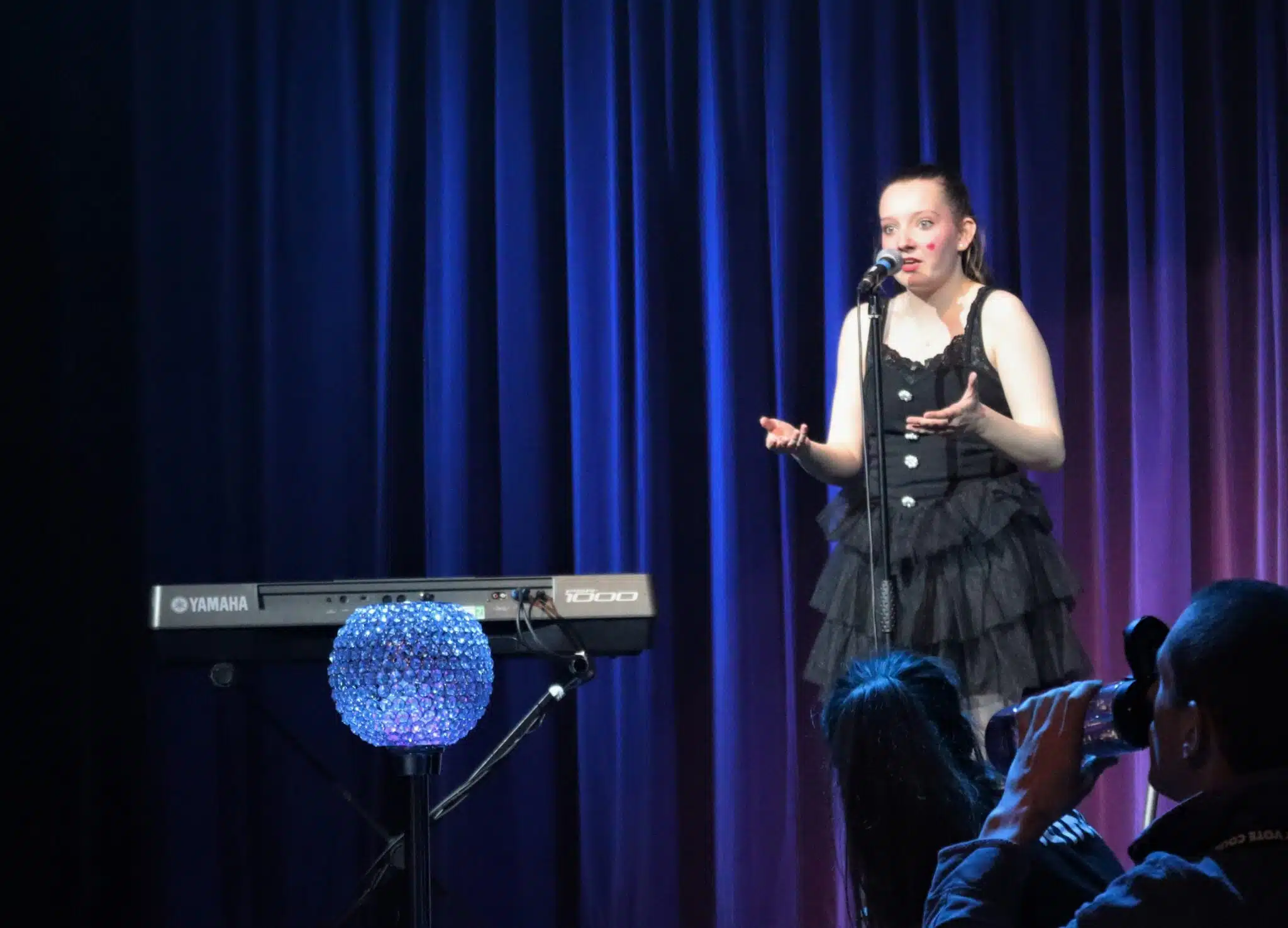 Student speaking in mic at cabaret
