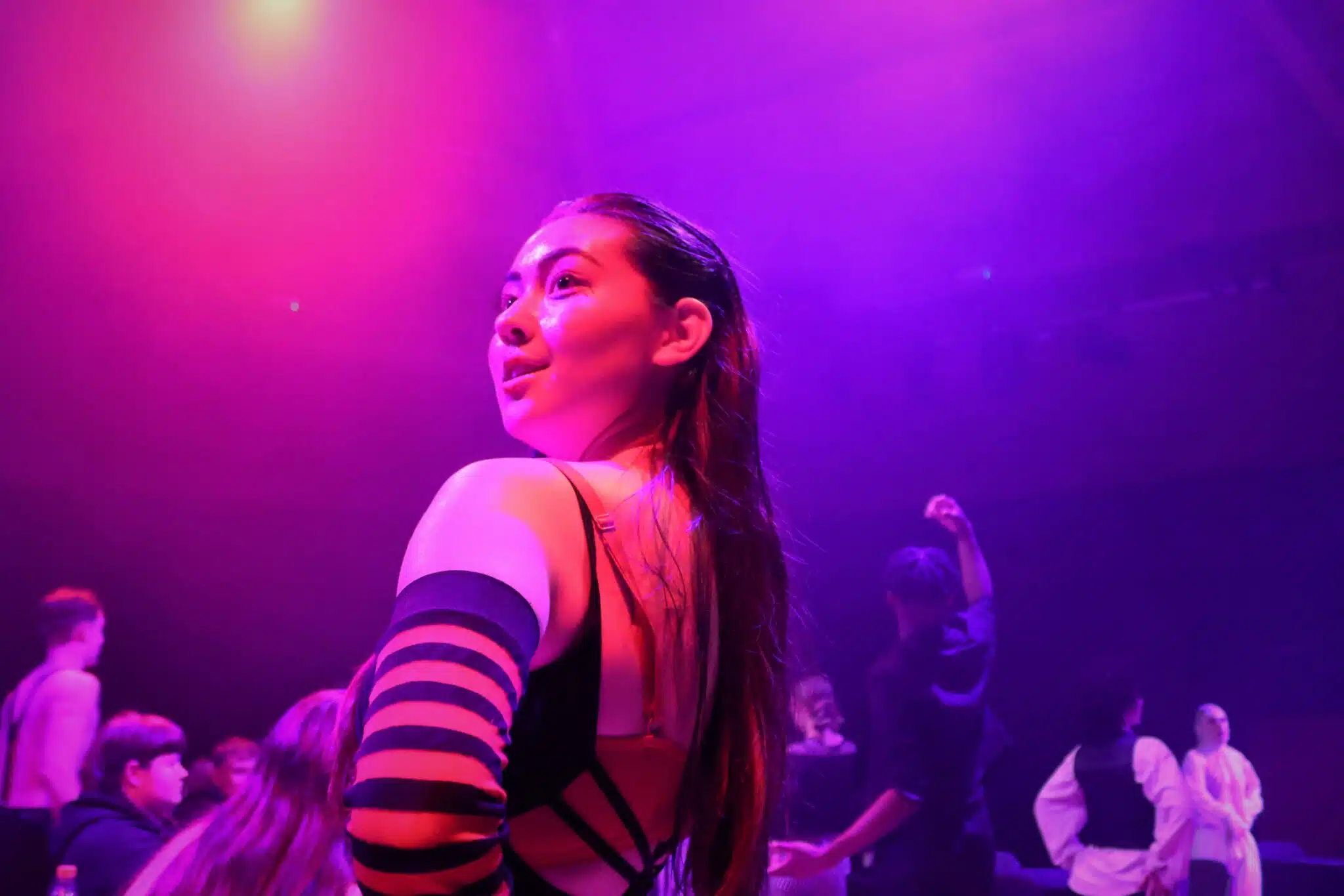 Student in pink and purple light in cabaret