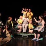 Stratford-upon-Avon College acting students perform live with photographer in foreground.