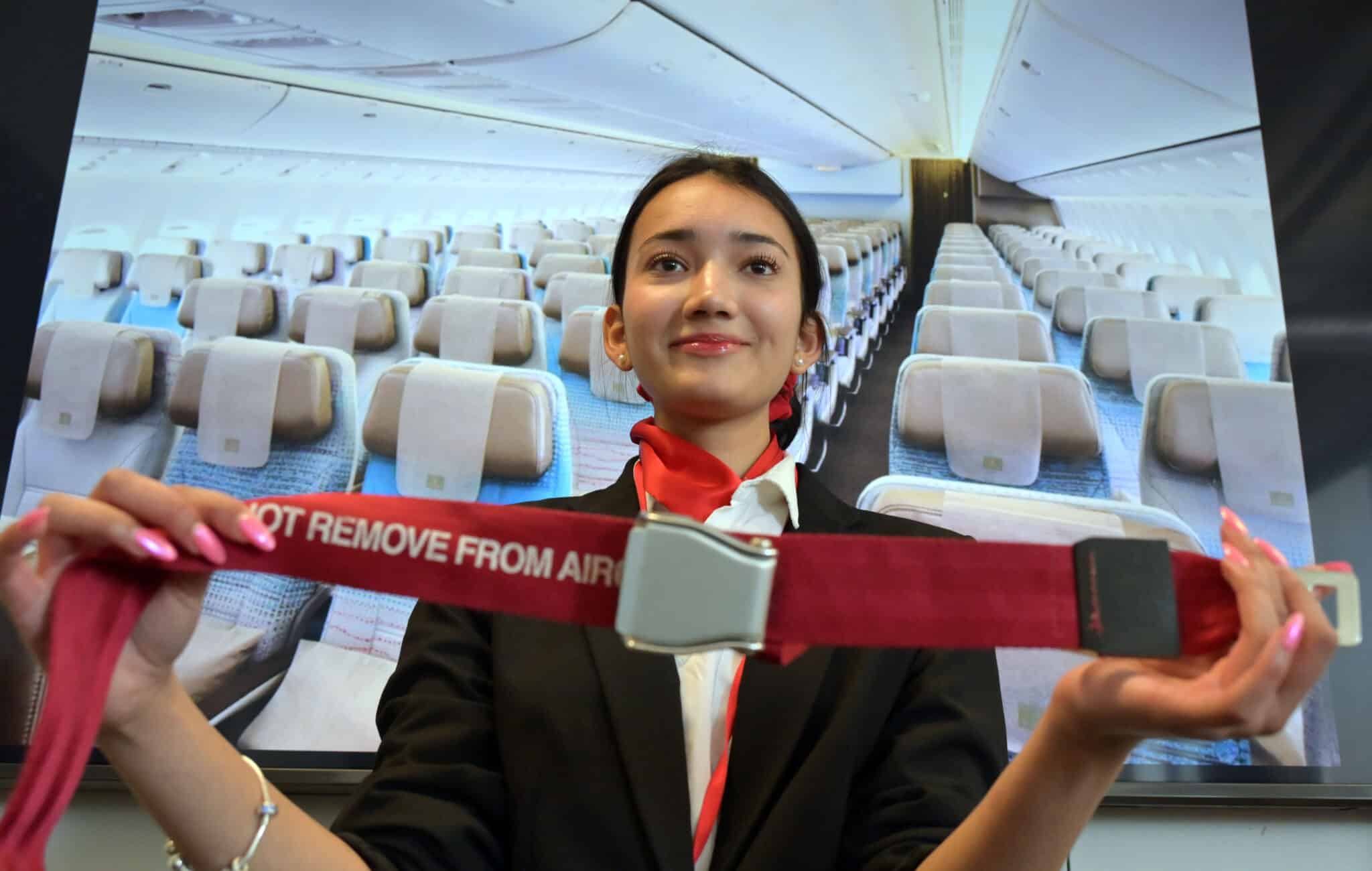 student with seat belt in cabin crew