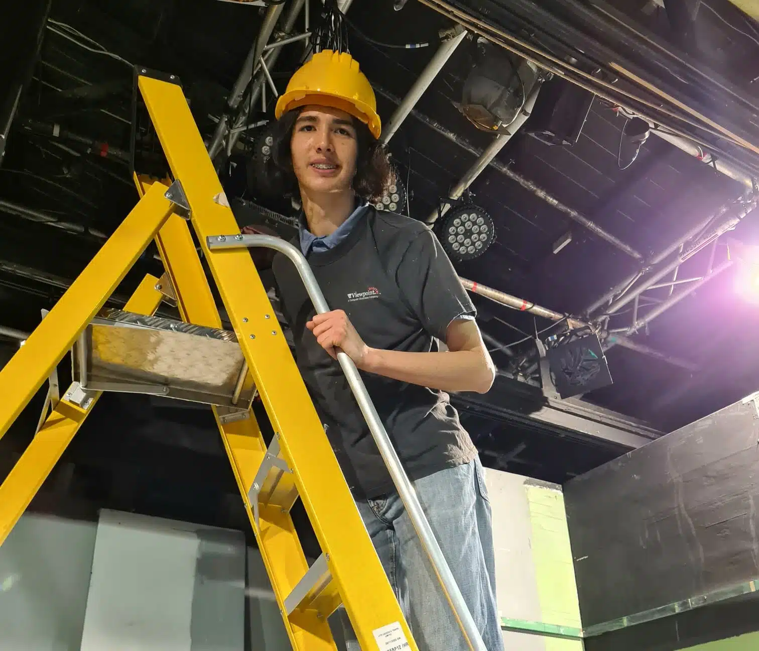 foundation learning student working on a ladder