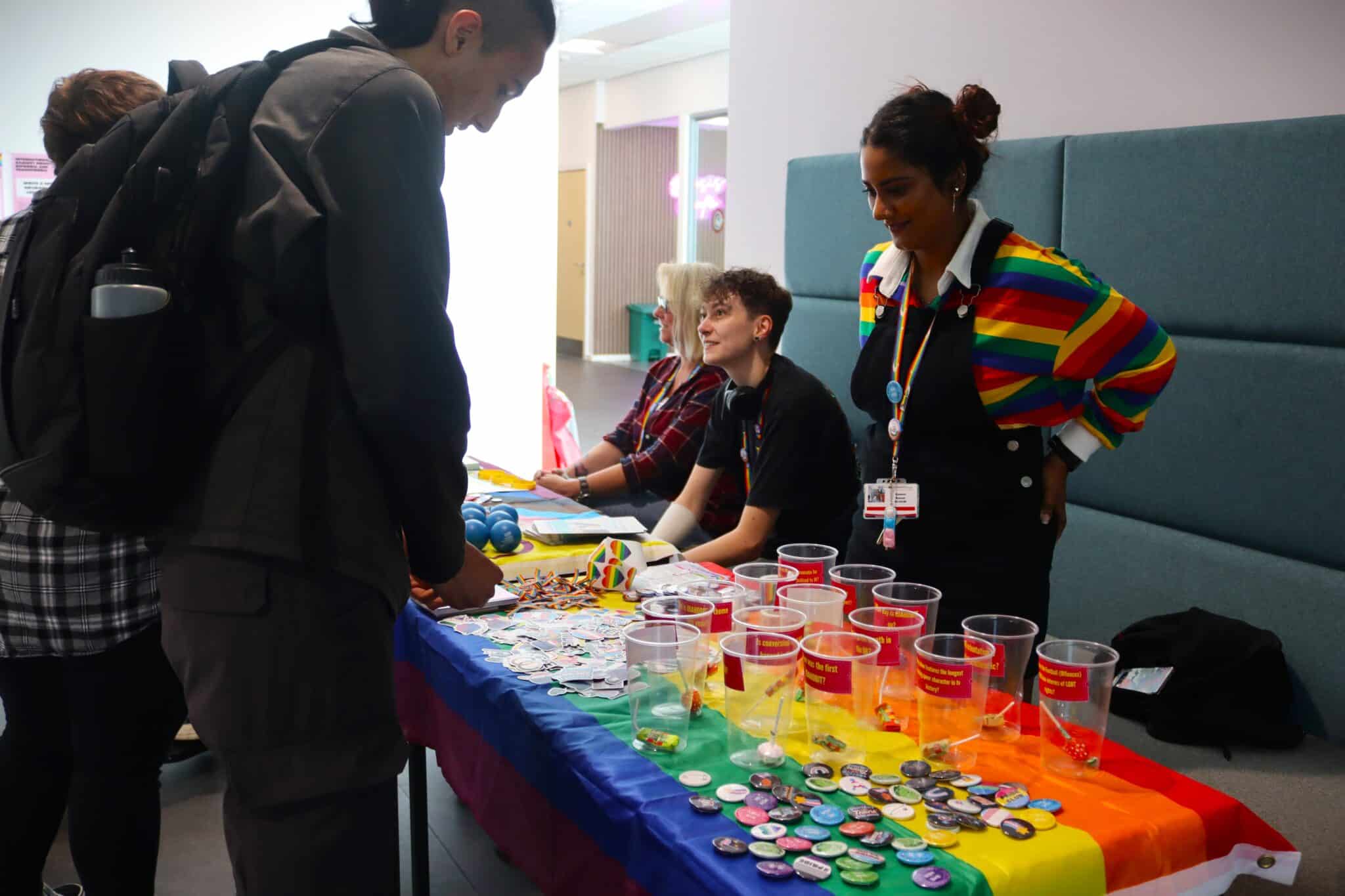 College celebrates Pride Month - table with badges and stickers