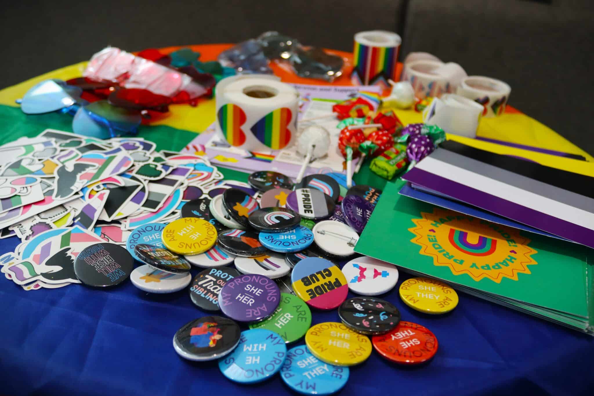 College celebrates Pride Month - table with badges, stamps and more