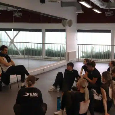 Students sat in a dance studio taking part in a Q&A